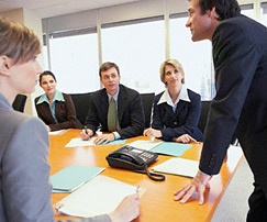 Man speaking to group at table